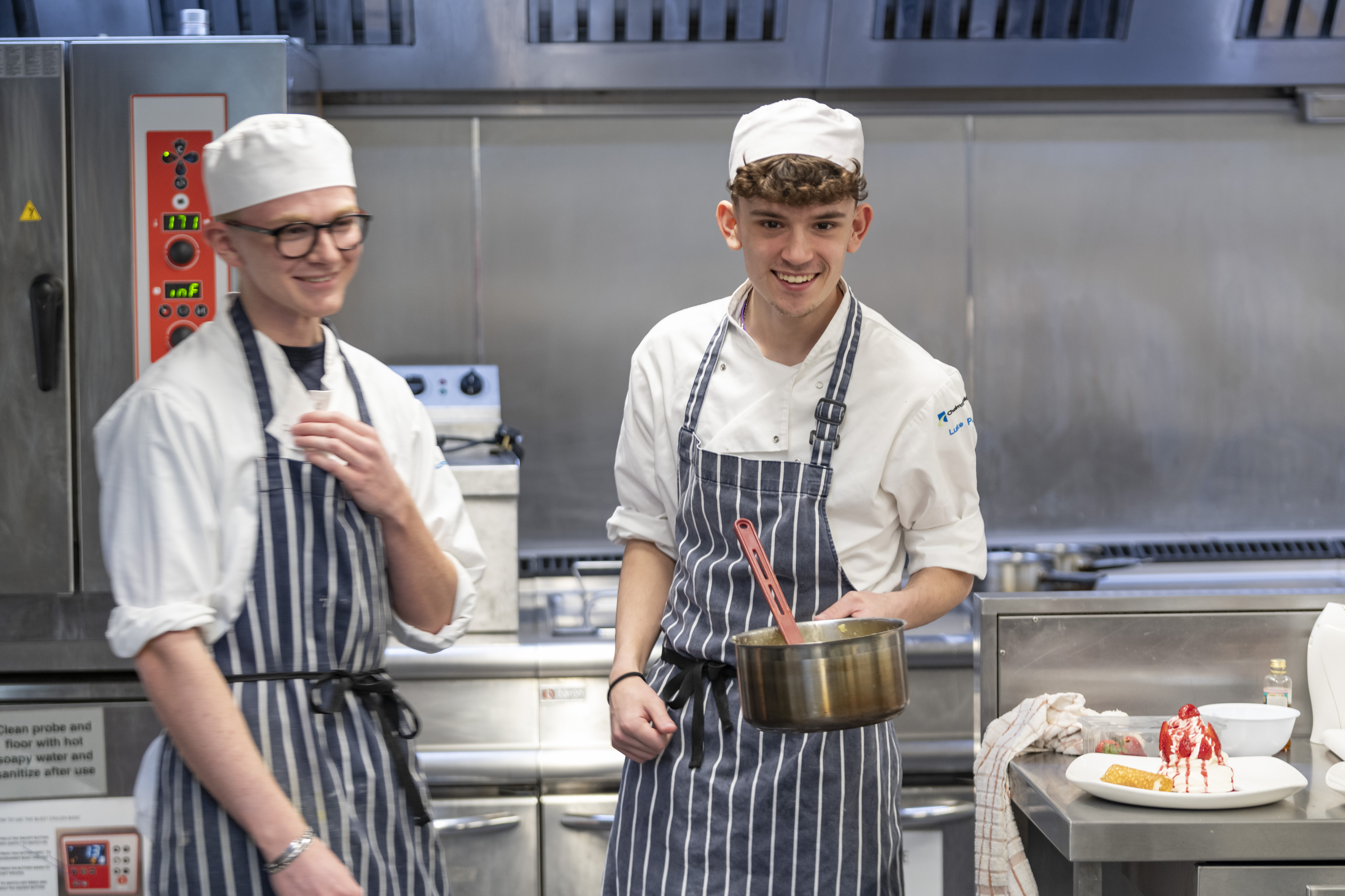 Catering students preparing food in a training kitchen